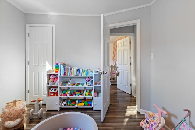 playroom featuring baseboards, wood finished floors, and crown molding