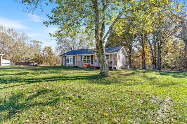 single story home with a front yard and a wooden deck