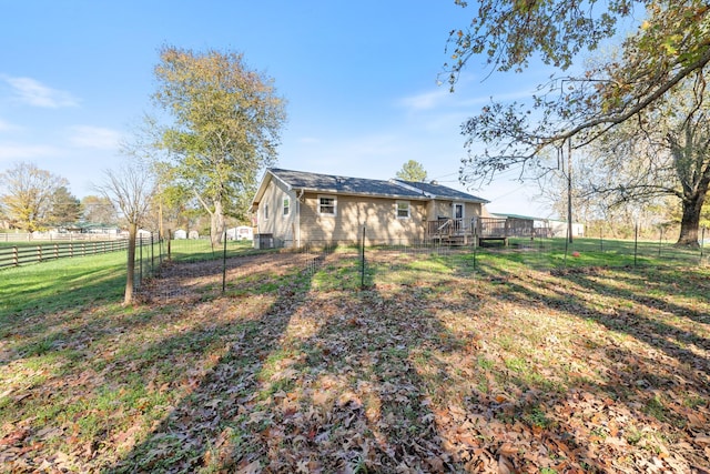 view of yard with fence and a wooden deck