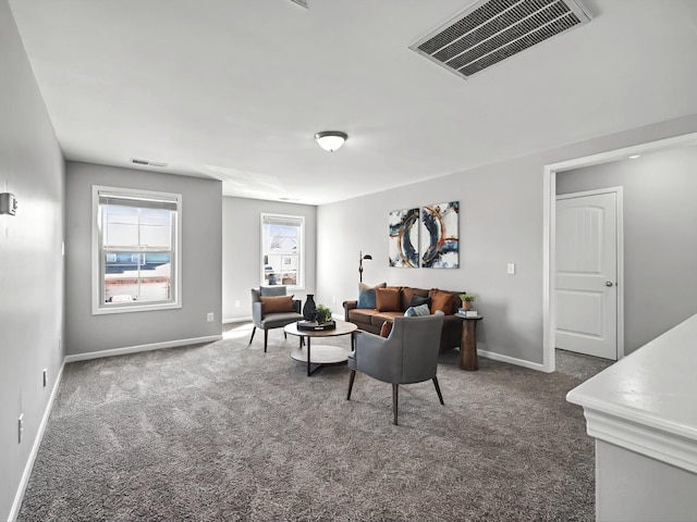 sitting room with baseboards, visible vents, and dark carpet