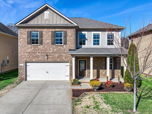 view of front of property featuring covered porch, a garage, brick siding, driveway, and board and batten siding