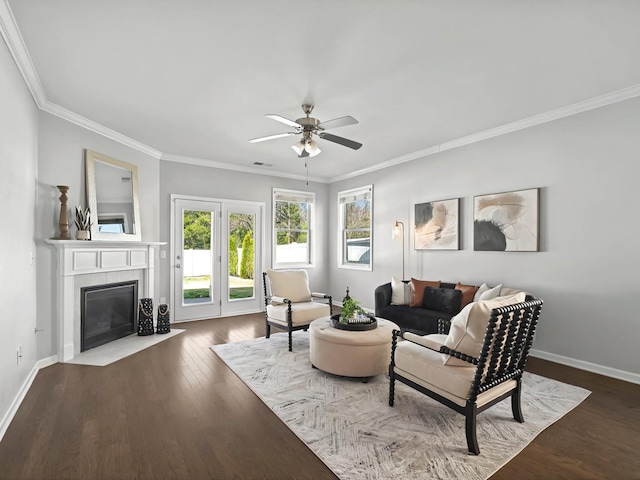 living area with dark wood-style floors, crown molding, a fireplace, and baseboards