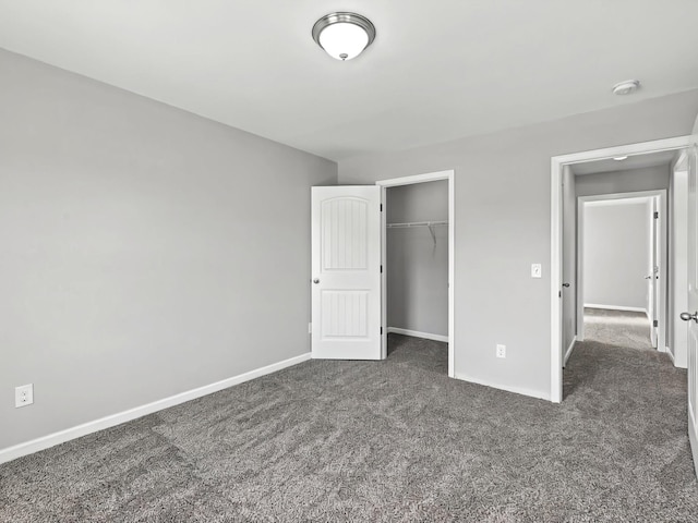 unfurnished bedroom featuring carpet, a closet, and baseboards