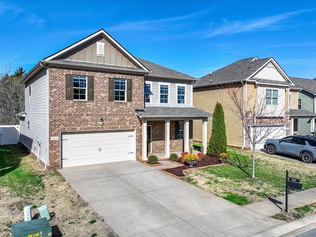 view of front of home with a porch, concrete driveway, an attached garage, board and batten siding, and a front lawn