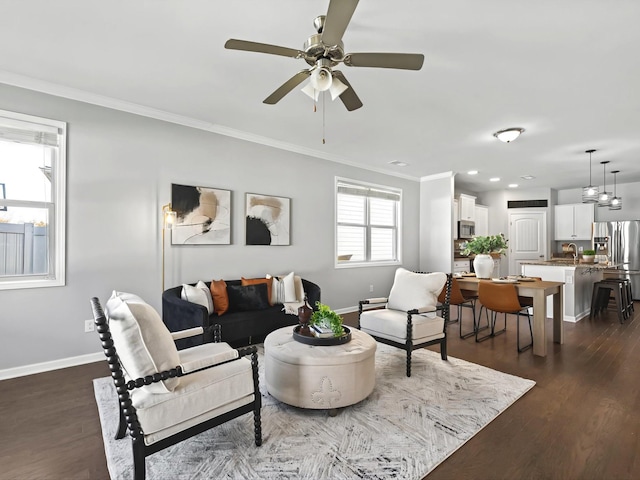 living room featuring baseboards, dark wood-style flooring, and crown molding