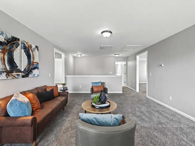 living area featuring baseboards, carpet, visible vents, and attic access