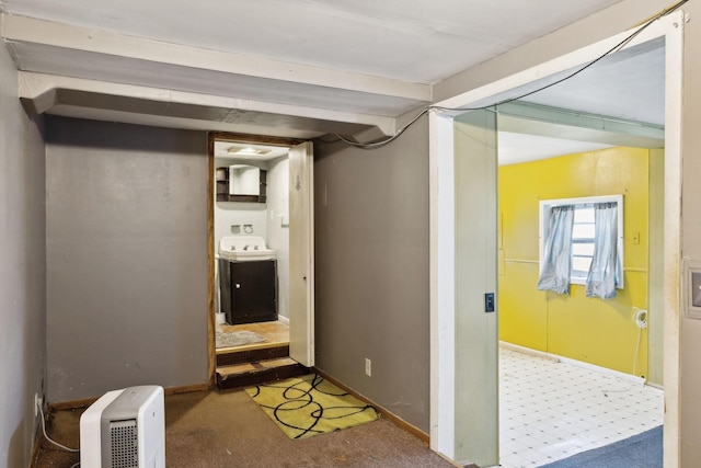 below grade area featuring washer / dryer, carpet, and baseboards