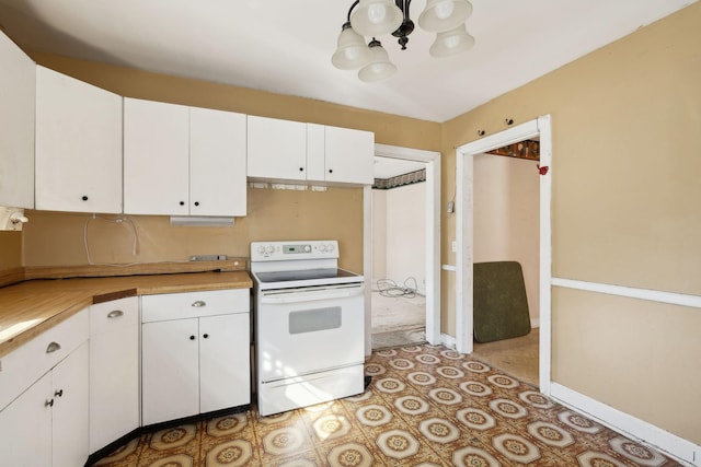 kitchen featuring light countertops, white electric range, baseboards, and white cabinetry