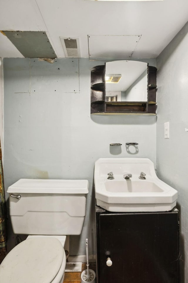 bathroom with toilet and vanity