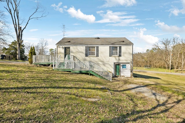 back of property with a deck and a yard