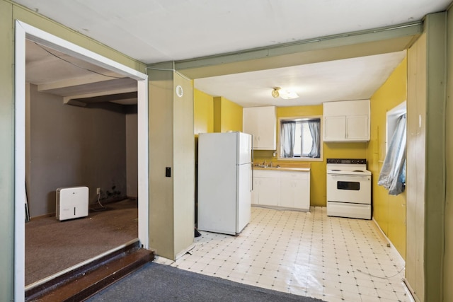 kitchen with light floors, white appliances, a sink, and white cabinetry