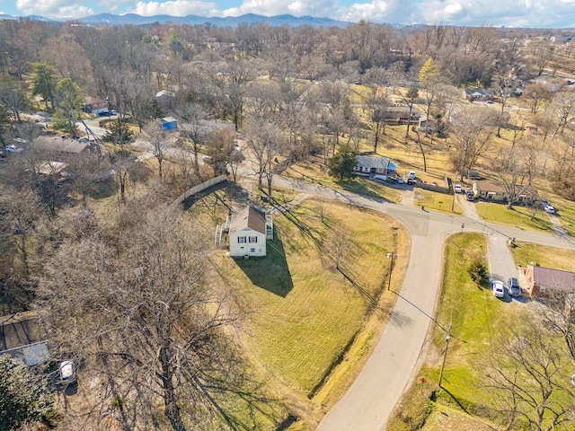 drone / aerial view featuring a forest view and a mountain view