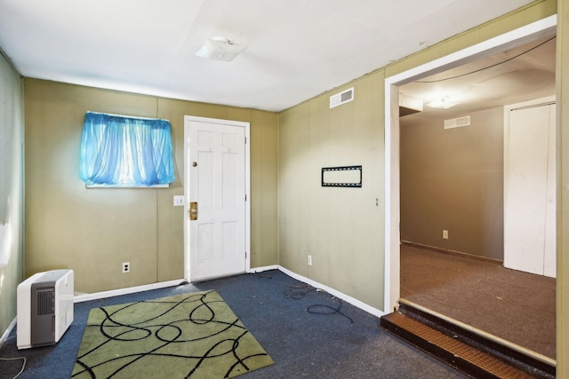 carpeted entryway with baseboards and visible vents