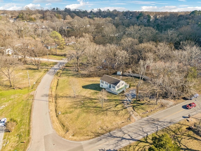 birds eye view of property featuring a wooded view