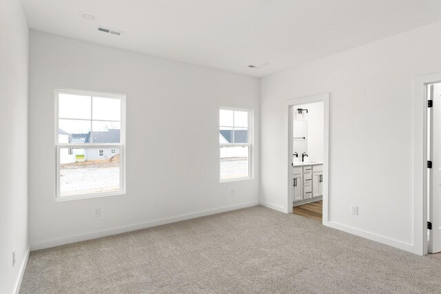 2383 Nelson Way, Cookeville, TN 38506 - unfurnished bedroom with light carpet, a sink, baseboards, and ensuite bath
