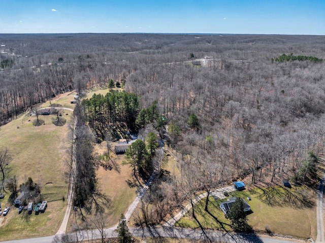 drone / aerial view featuring a forest view