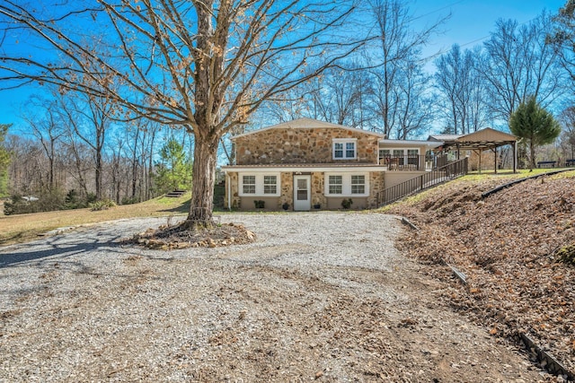 view of front facade featuring stone siding and driveway