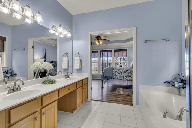 full bath featuring a sink, ensuite bath, and tile patterned floors