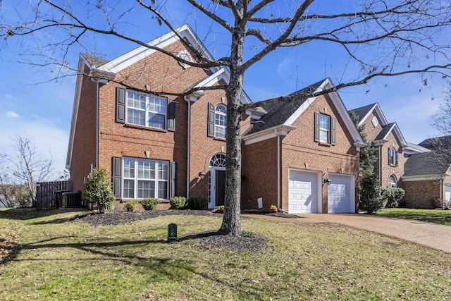 traditional home featuring driveway, a garage, fence, a front lawn, and brick siding