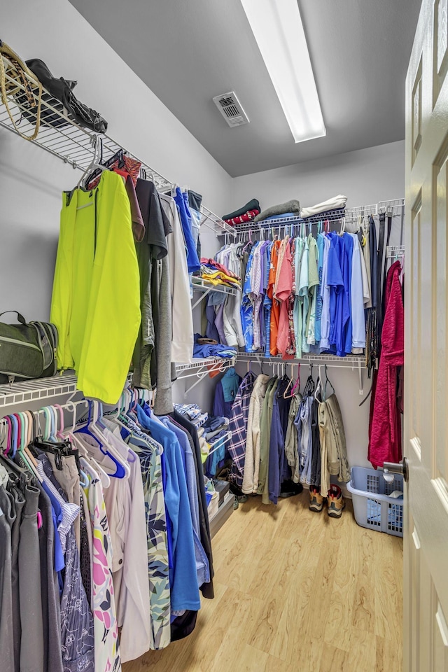 spacious closet featuring visible vents and wood finished floors