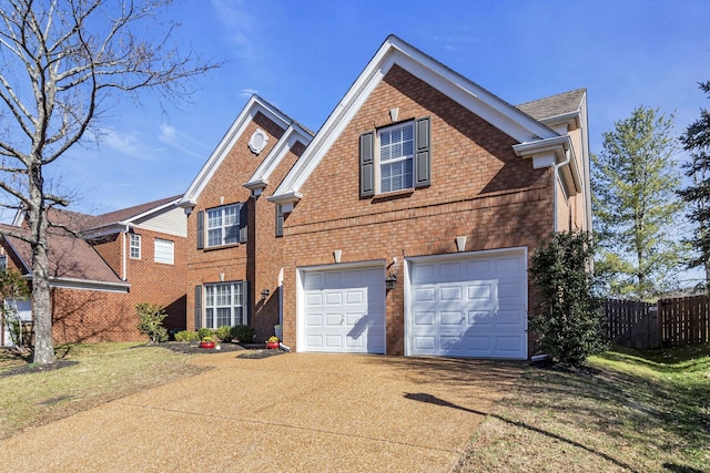 view of front of home with concrete driveway, an attached garage, fence, a front lawn, and brick siding