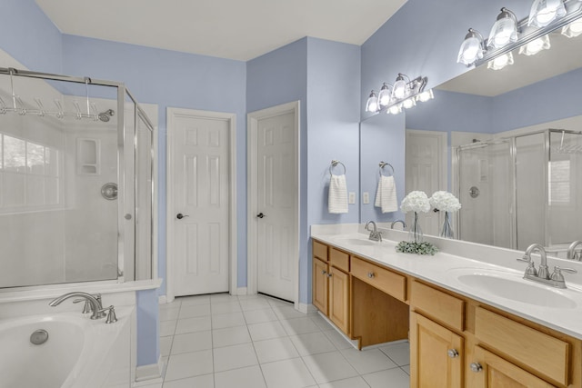 full bathroom featuring double vanity, tile patterned flooring, a shower stall, and a sink