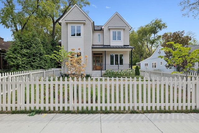 3809A Murphy Rd, Nashville, TN 37209 - view of front of property with a fenced front yard, metal roof, a standing seam roof, covered porch, and brick siding