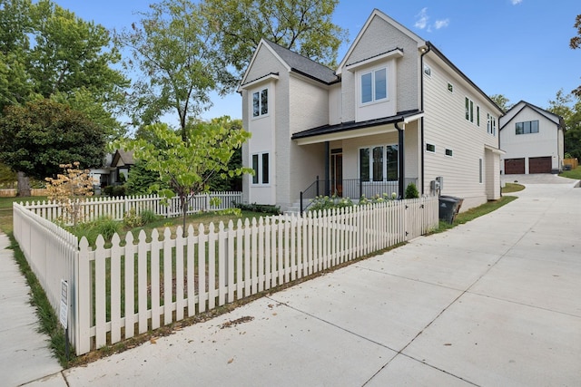 traditional home with a fenced front yard and concrete driveway