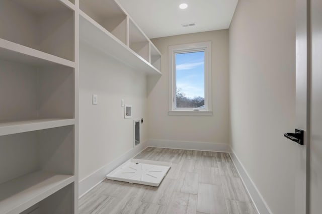 laundry room with hookup for a washing machine, visible vents, hookup for an electric dryer, laundry area, and baseboards