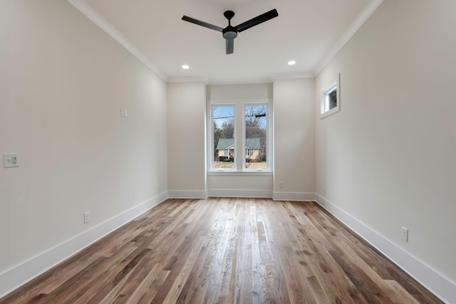 empty room with crown molding, recessed lighting, wood finished floors, and baseboards