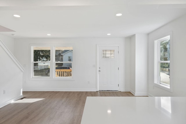 entryway with recessed lighting, wood finished floors, and a healthy amount of sunlight