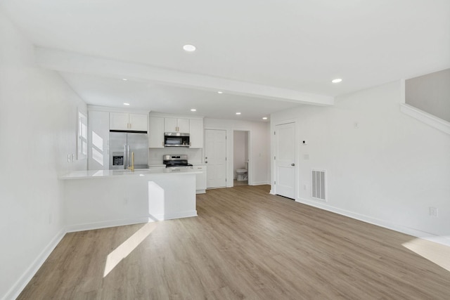 kitchen featuring light countertops, visible vents, appliances with stainless steel finishes, light wood-style floors, and white cabinets