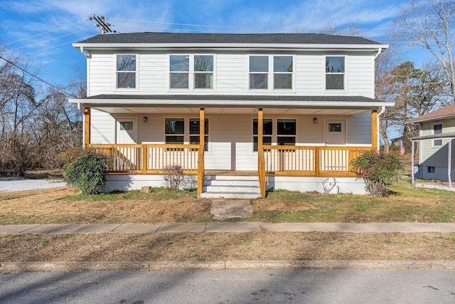 view of front of property with a porch and roof with shingles