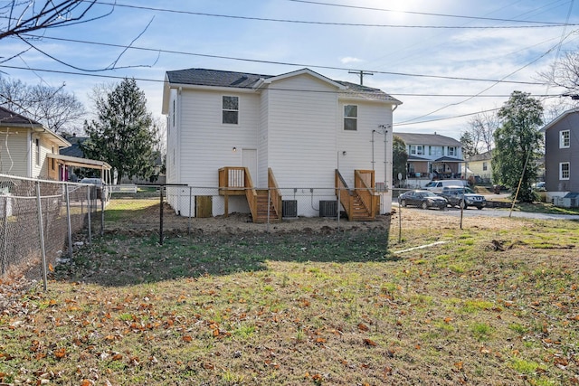 rear view of property with central AC and fence