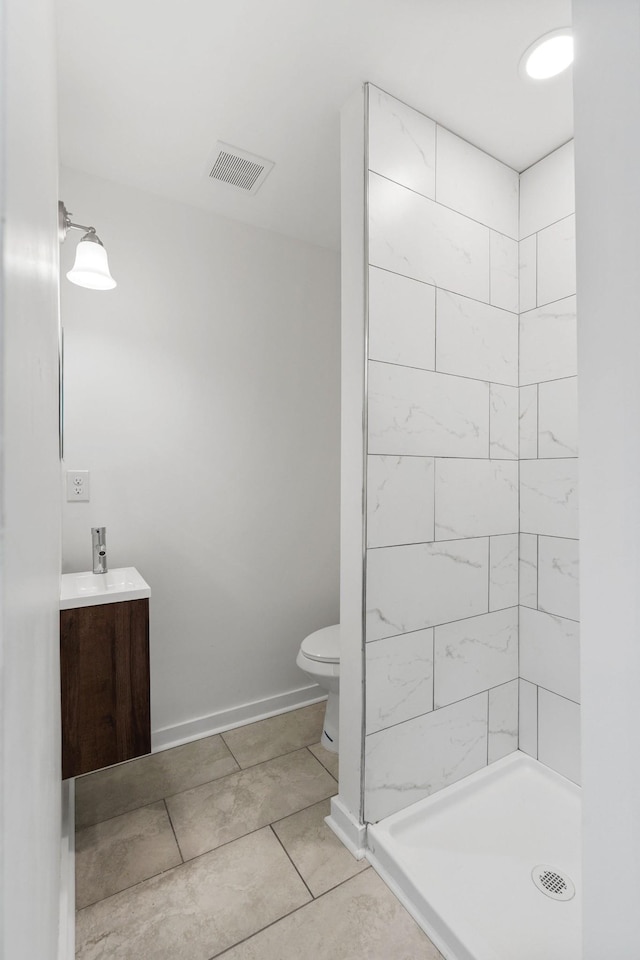 full bathroom with a stall shower, baseboards, visible vents, toilet, and vanity