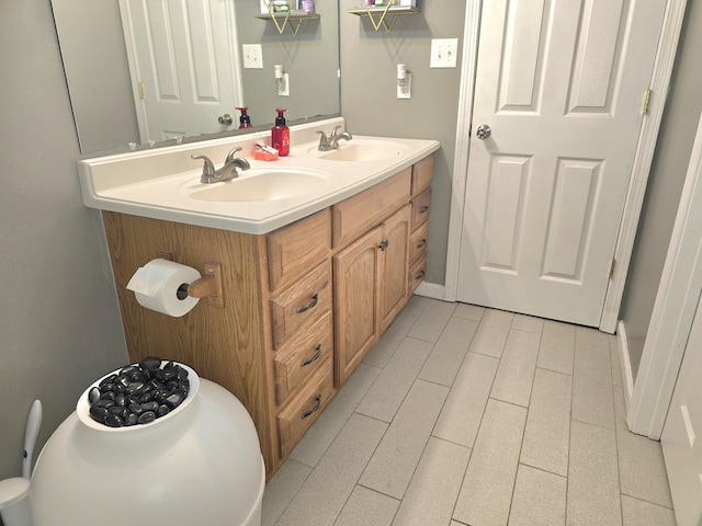 bathroom featuring a sink and double vanity