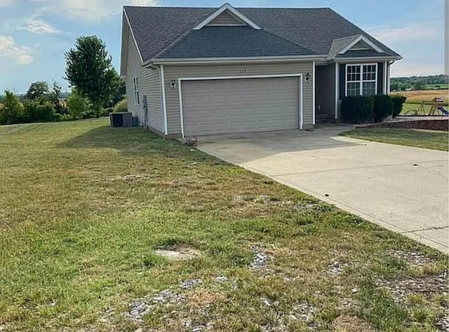 view of front of house with driveway, a front lawn, an attached garage, and central air condition unit