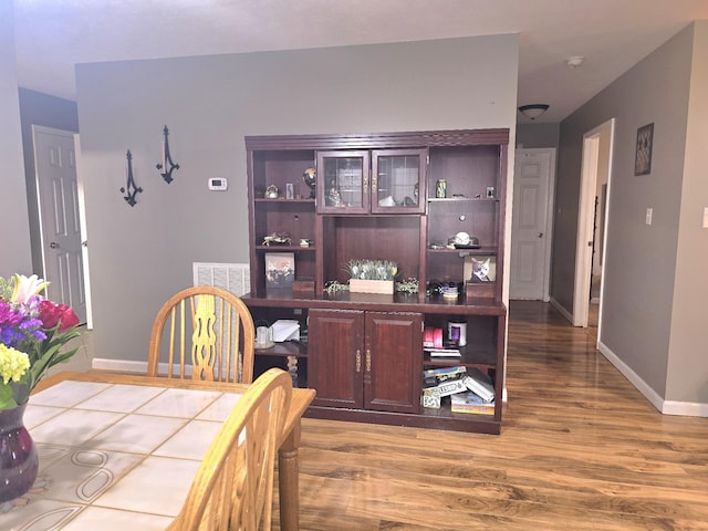 dining area featuring baseboards and wood finished floors