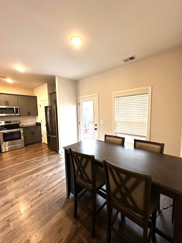 dining room featuring visible vents and wood finished floors