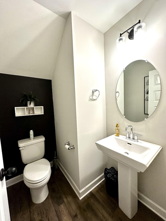 bathroom featuring toilet, baseboards, and wood finished floors