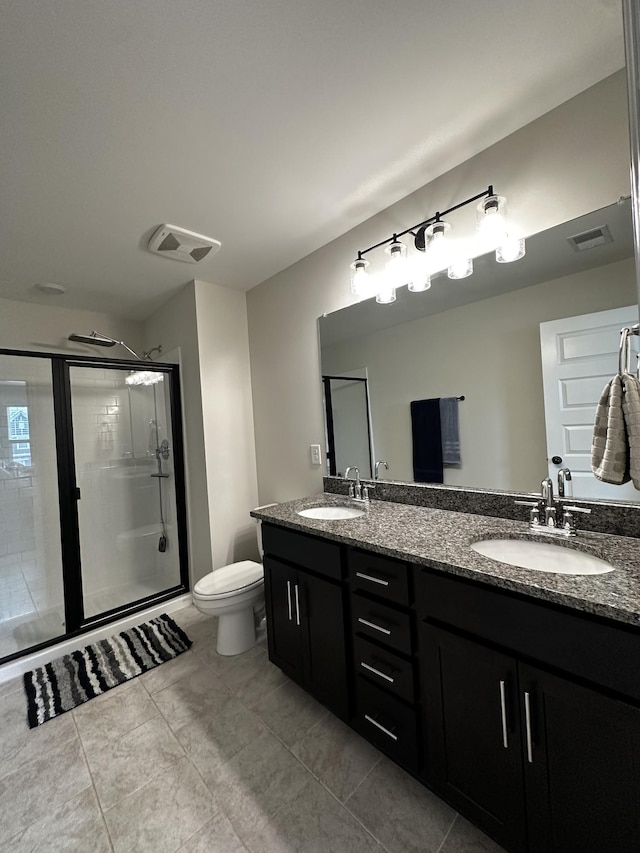 full bathroom with double vanity, a sink, toilet, and a shower stall