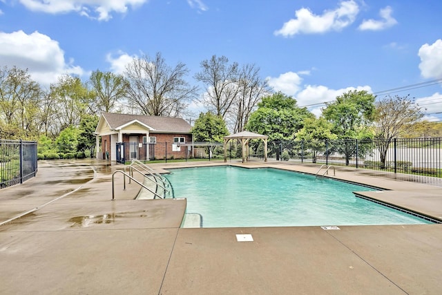 pool featuring a patio area, fence, an outbuilding, and a gazebo