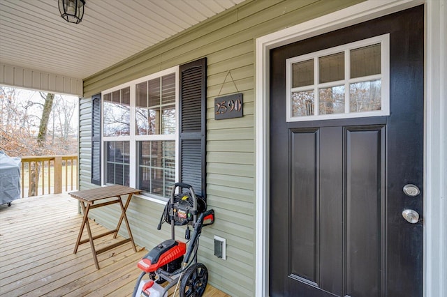 view of exterior entry featuring covered porch