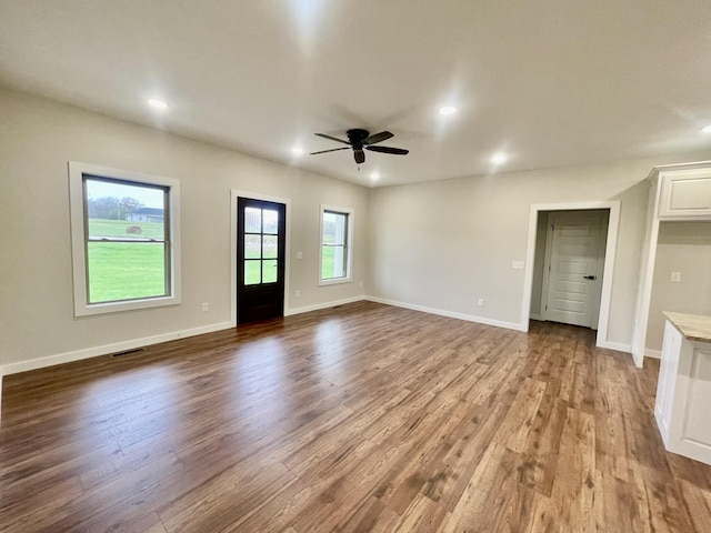 unfurnished living room with recessed lighting, dark wood finished floors, baseboards, and ceiling fan