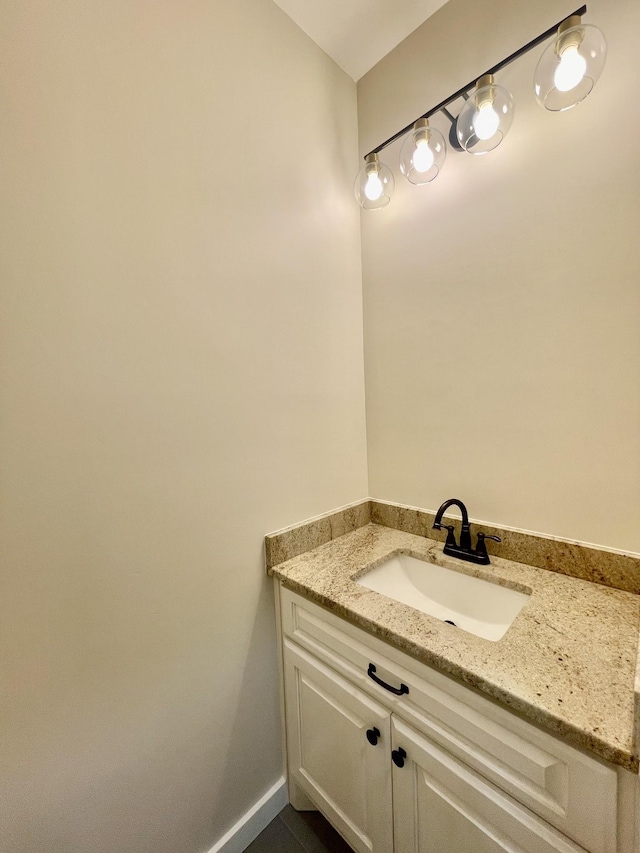 bathroom with baseboards and vanity