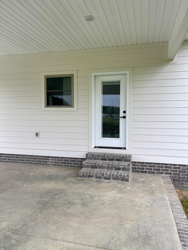 entrance to property with a patio