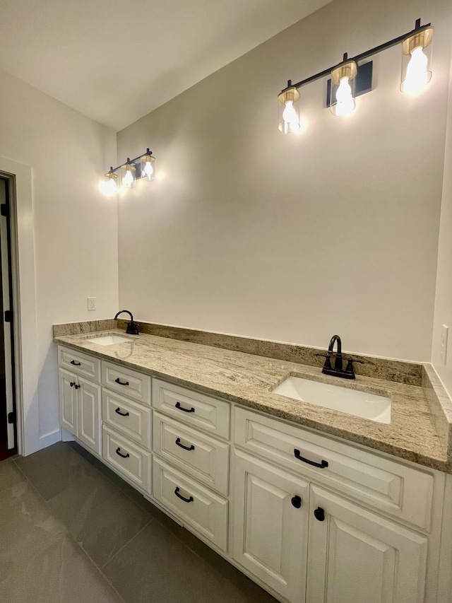 bathroom with double vanity, tile patterned flooring, and a sink