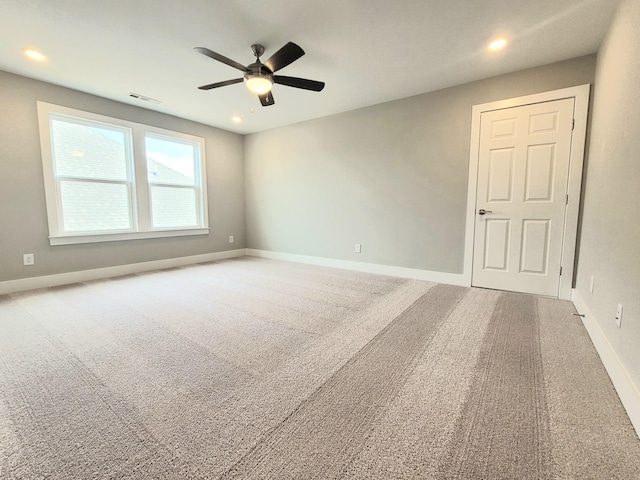 carpeted spare room featuring baseboards, visible vents, ceiling fan, and recessed lighting