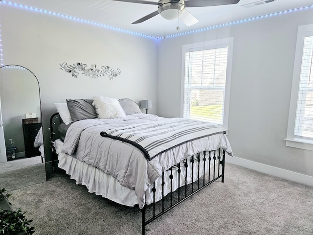 bedroom featuring a ceiling fan, carpet, visible vents, and baseboards