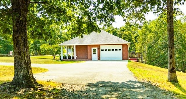 view of front of house with driveway, a front lawn, and an attached garage